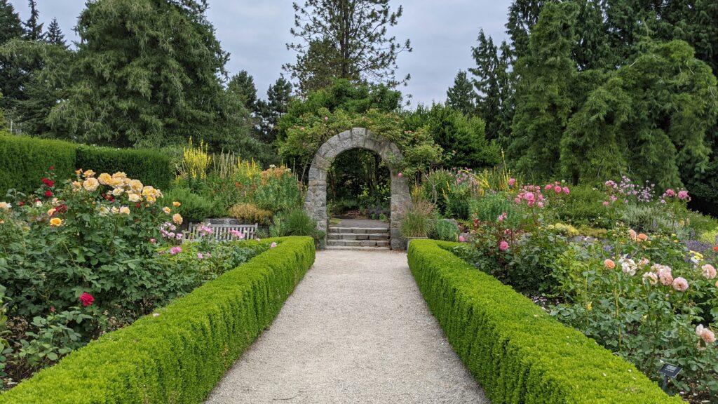 Rock Arch surrounded by path with roses at VanDusen Botanical Garden