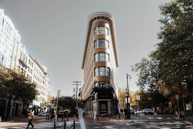 a tall building sitting on the side of a street.

vancouver
gastown
bc
canada
building
street
building construction
hotel
city
urban
road
condo
housing
high rise
apartment building
car
vehicle
pedestrian
person
walking