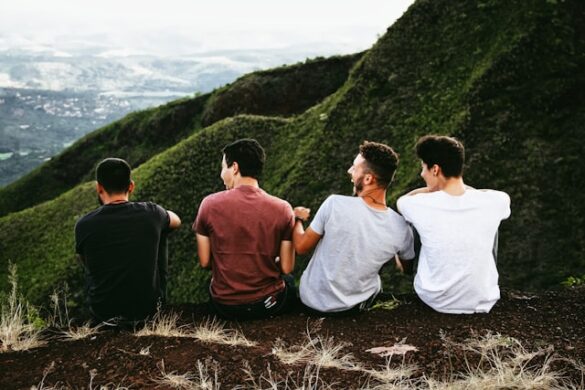 row of four men sitting on mountain trail. people friend men friendship group man website travel belo horizonte happy friends happy life boys friends laugh laughing edge sat sit sitting male