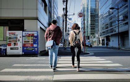 alt="man and woman dating, walking on street during daytime"