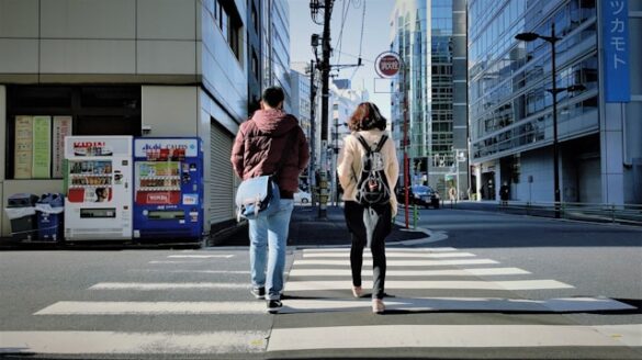 alt="man and woman dating, walking on street during daytime"