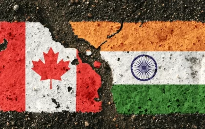 India and Canada flags merging on a pavement