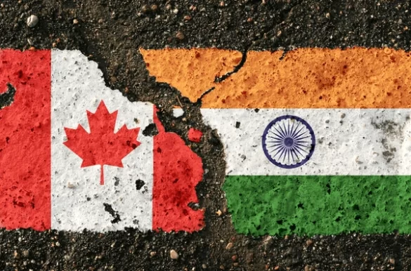 India and Canada flags merging on a pavement